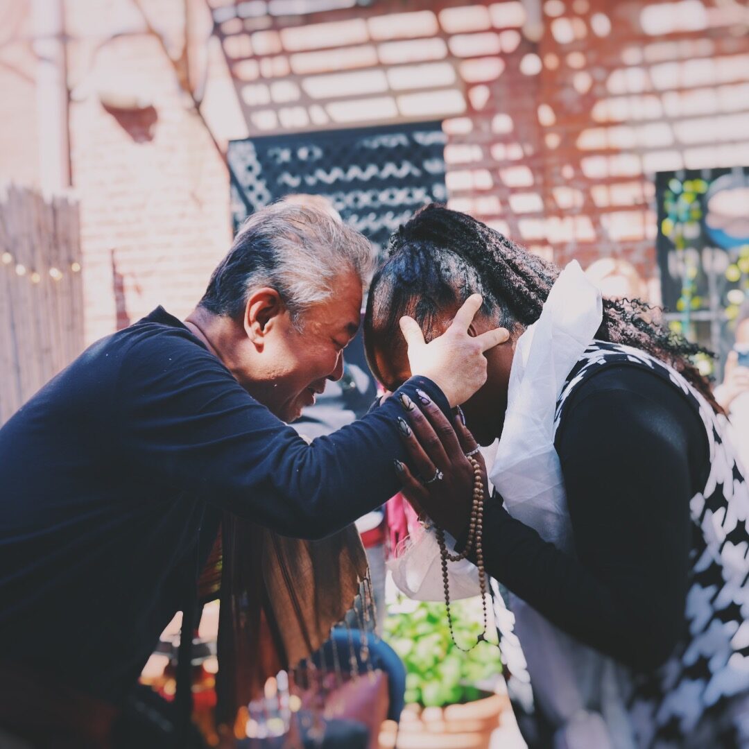 Drupon blessing a student